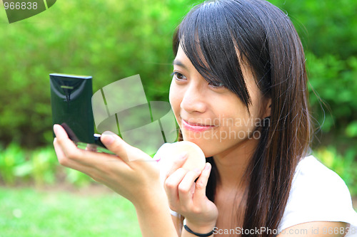 Image of girl doing makeup