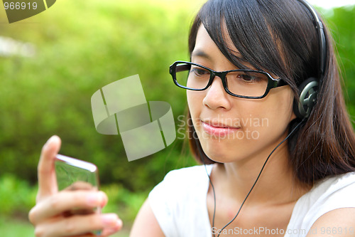 Image of Pretty young girl listening music