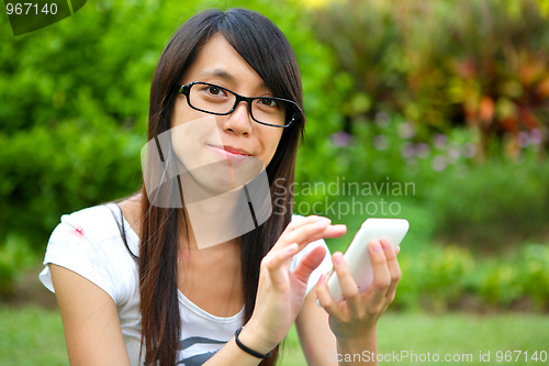 Image of Beautiful young girl with pda outdoor