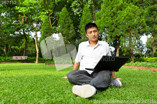 Image of man using computer outdoor