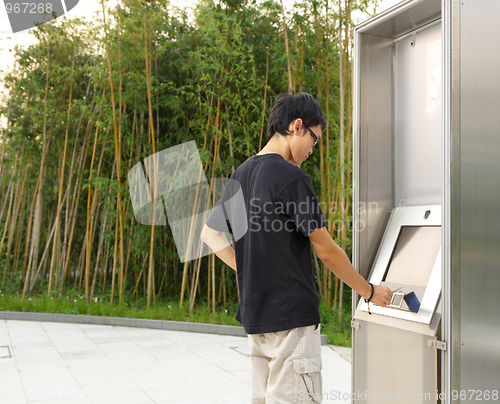 Image of man using touch screen outdoor