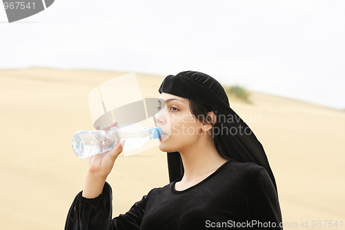 Image of Woman drinking water from bottle