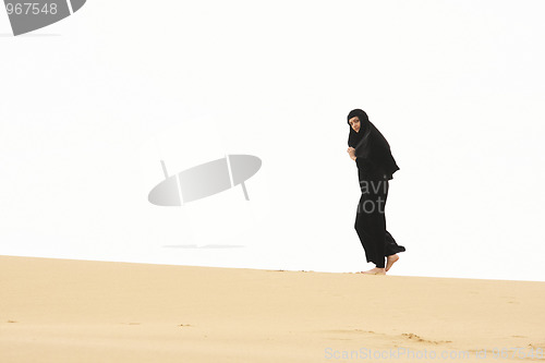 Image of Woman walking by sand hill crest