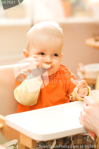 Image of Baby boy playing with spoon