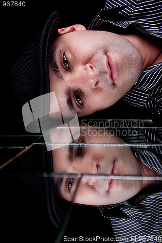 Image of handsome man, with reflexion of the face on the mirror