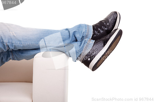 Image of Detail, of some legs stretched on the couch