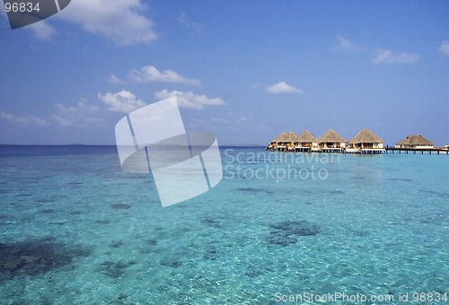 Image of water bungalows at the sea and sky background