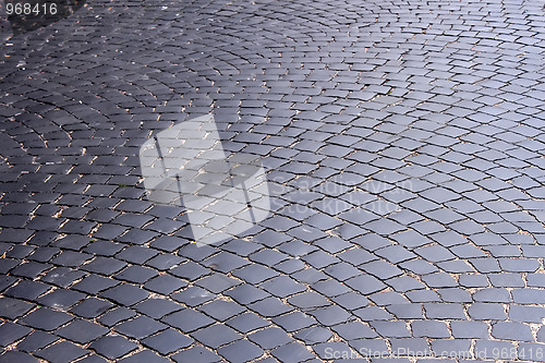 Image of The road, covered with black stones