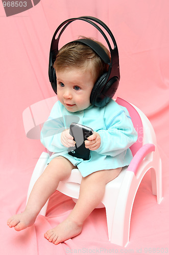 Image of baby in headphones on chamber-pot