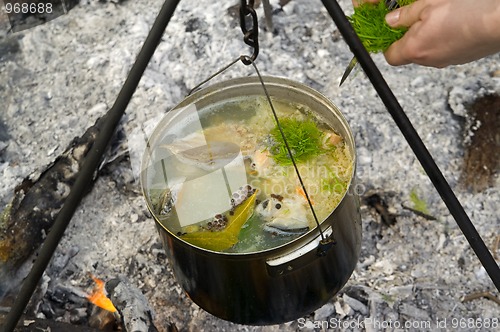 Image of Cooking fish soup on the fire