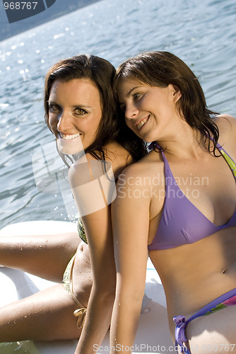Image of Girls relaxing on surfboard