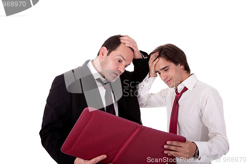 Image of two businessmen talking about work, tired and worried, looking for a document