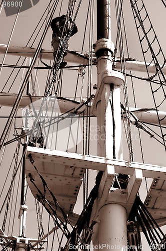 Image of Climbing up a mast. Sepia