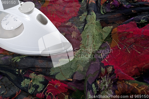 Image of Ironing colorful silk fabric