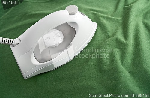 Image of White iron on green cloth