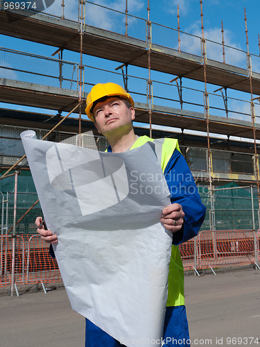 Image of Foreman on buiding site looks up