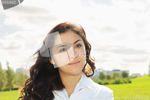 Image of Young pensive brunette looking sideways