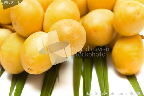 Image of Bunch of fresh dates on the leaf