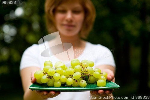 Image of Girl holding green grapes