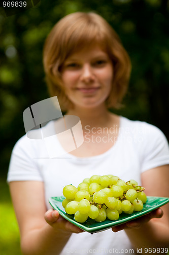 Image of Girl holding green grapes