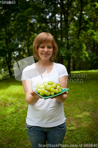 Image of Girl holding green grapes