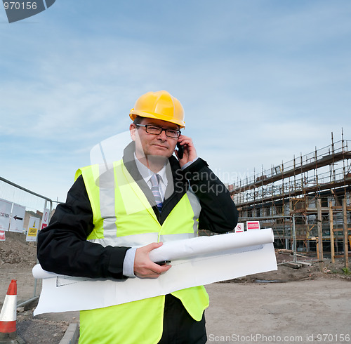 Image of Architect on building site phoning