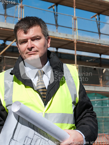 Image of Smiling, confident architect looks at camera