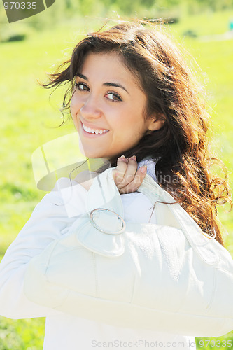 Image of Young woman with white bag at shoulder