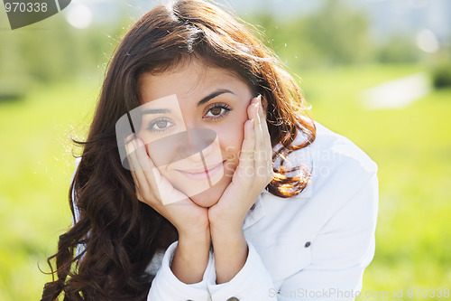 Image of Young brunette leaning on hands