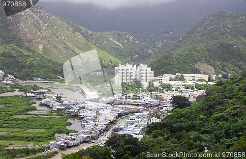 Image of Small fishing village at a base of a high mountain