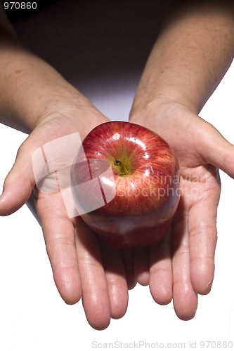 Image of Woman holding fresh apple from dark to light