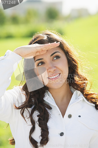 Image of Brunette looking up from under hand peak