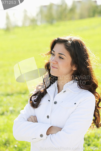 Image of Young confident brunette looking sideways