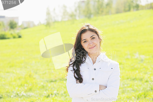 Image of Young brunette arms folded