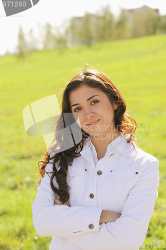 Image of Young confident brunette arms folded