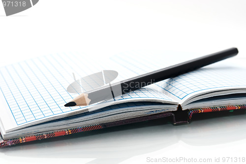 Image of close up of notebook and pencil