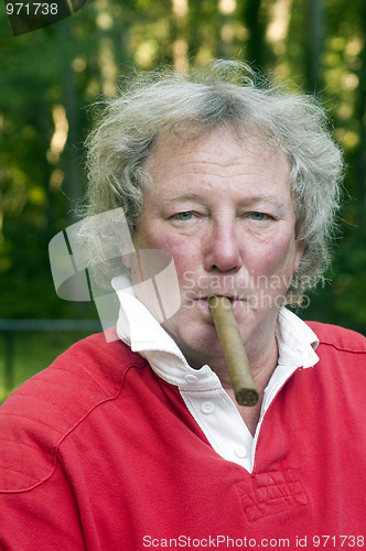 Image of senior man smoking big cigar