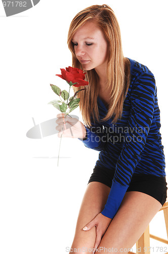 Image of Girl smelling rose.