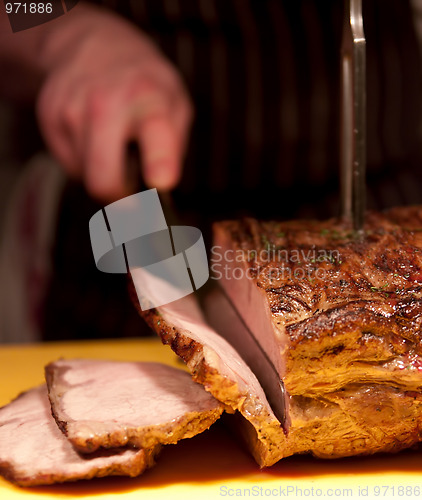 Image of Chef slices roast pork