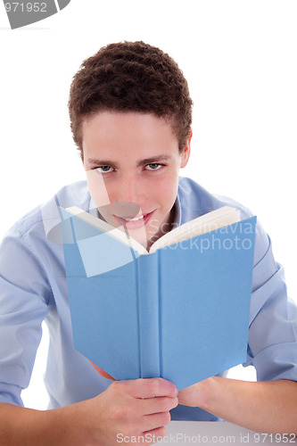 Image of cute boy reading a book on his desk