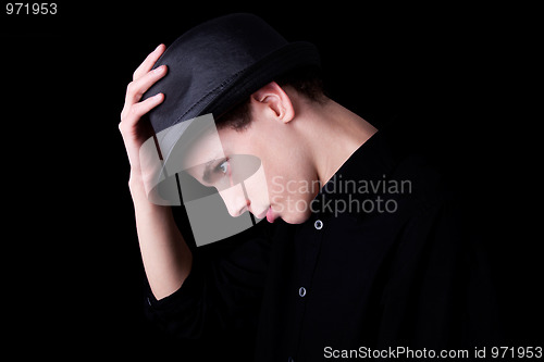 Image of Young man wearing a hat over black background