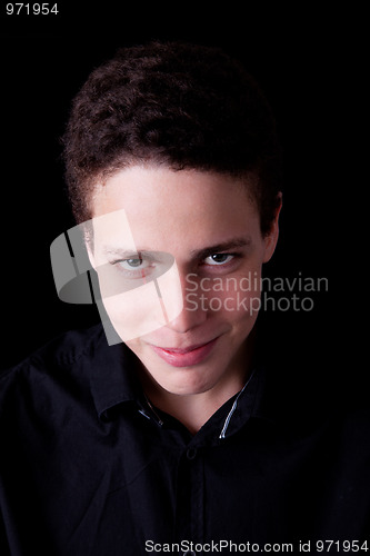 Image of cute boy, smiling and looking to camera on black
