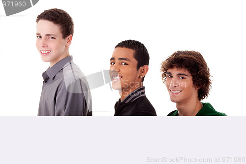 Image of three young, of different colors man holding a white board