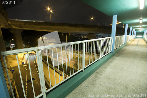 Image of view on footbridge of modern urban city with Freeway Traffic at 