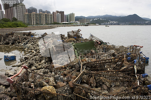 Image of Garbage piled up on the coast of the ocean. 