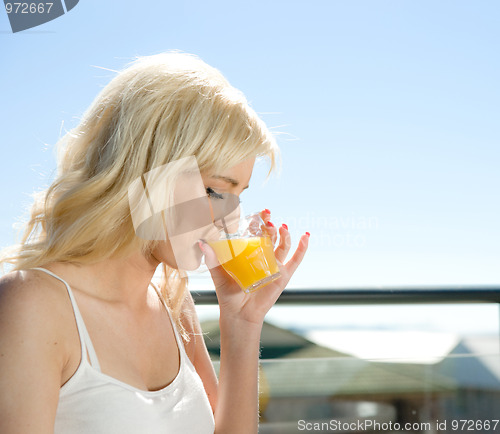 Image of woman drinking orange juice