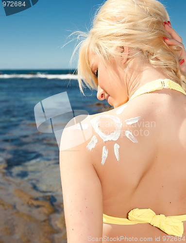 Image of young woman with sunscreen sun