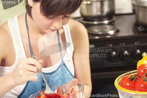 Image of Housewife mixing salad
