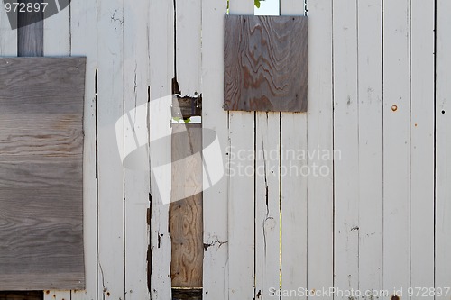 Image of Heavily repaired wooden fence  