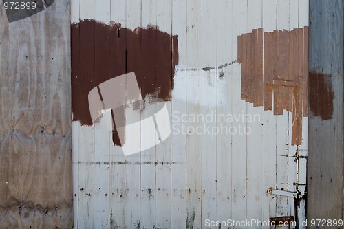 Image of Repaired and painted wooden fence 